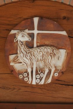 Agnus Dei, fireclay, tympan above the church door